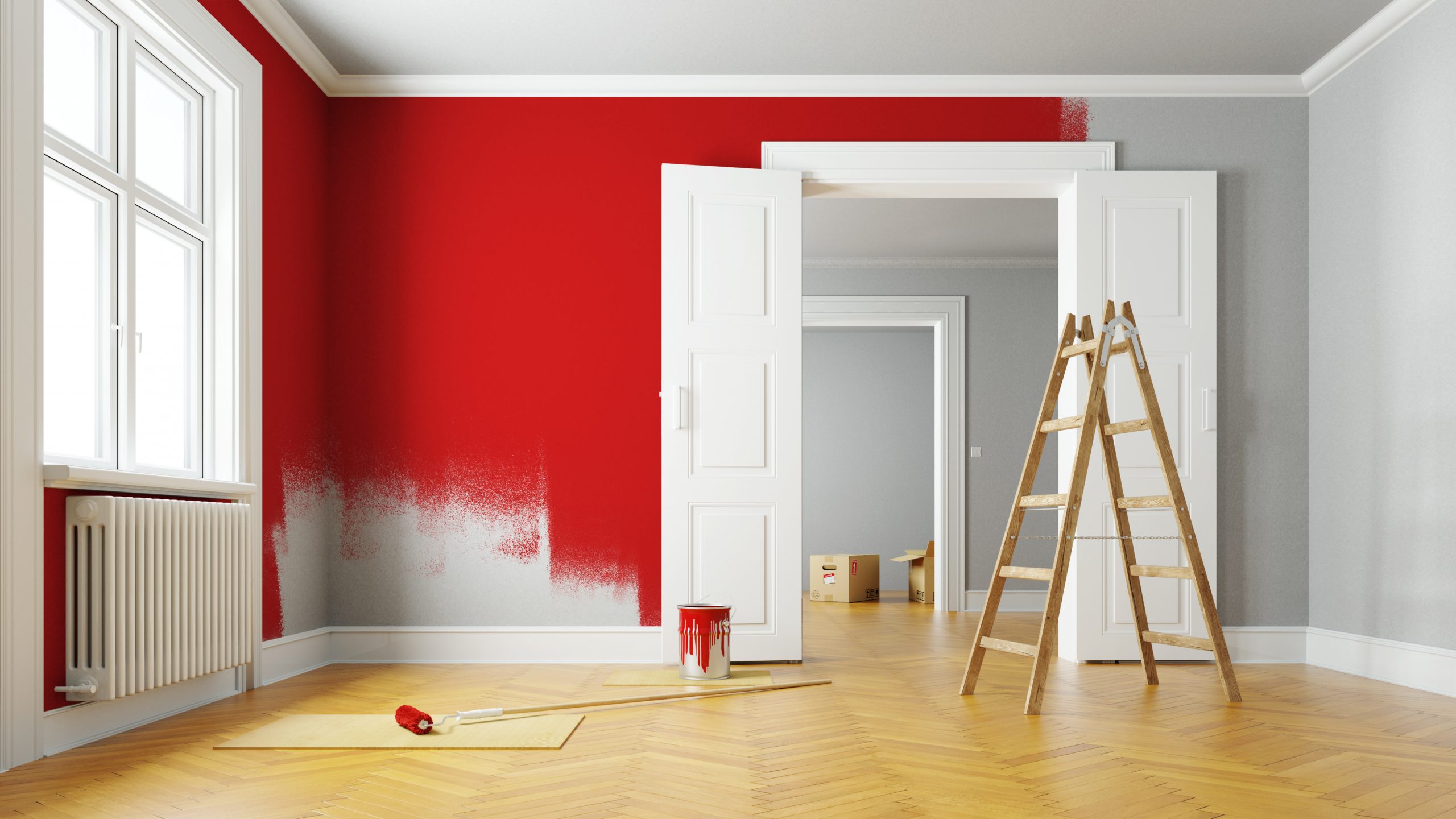 Peindre le mur en rouge lors d'une rénovation dans une grande pièce vide